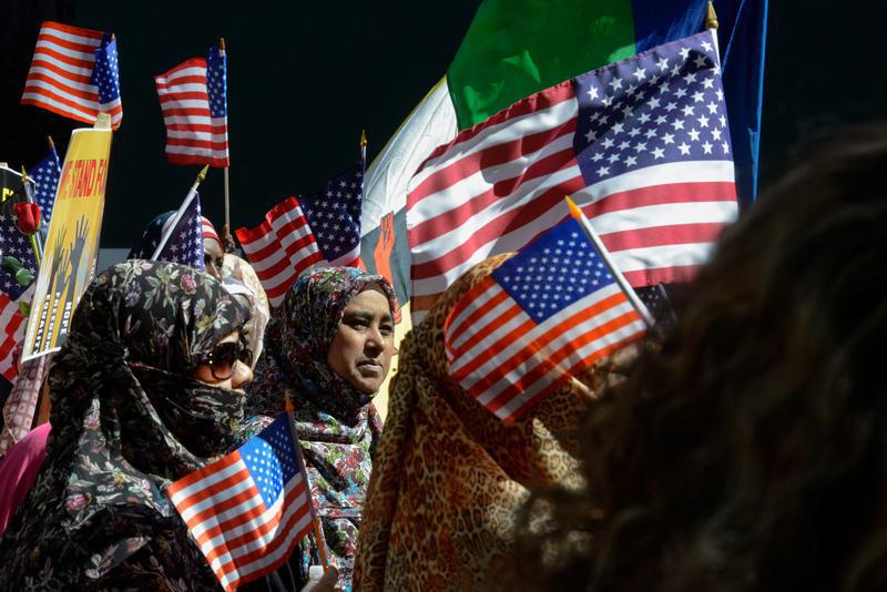 People participating in the annual Muslim Day Parade carry U.S. flags in the Manhattan borough of New York City, September 25, 2016. 