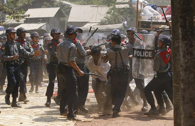 Police hit a student protester in Letpadan on March 10, 2015. 