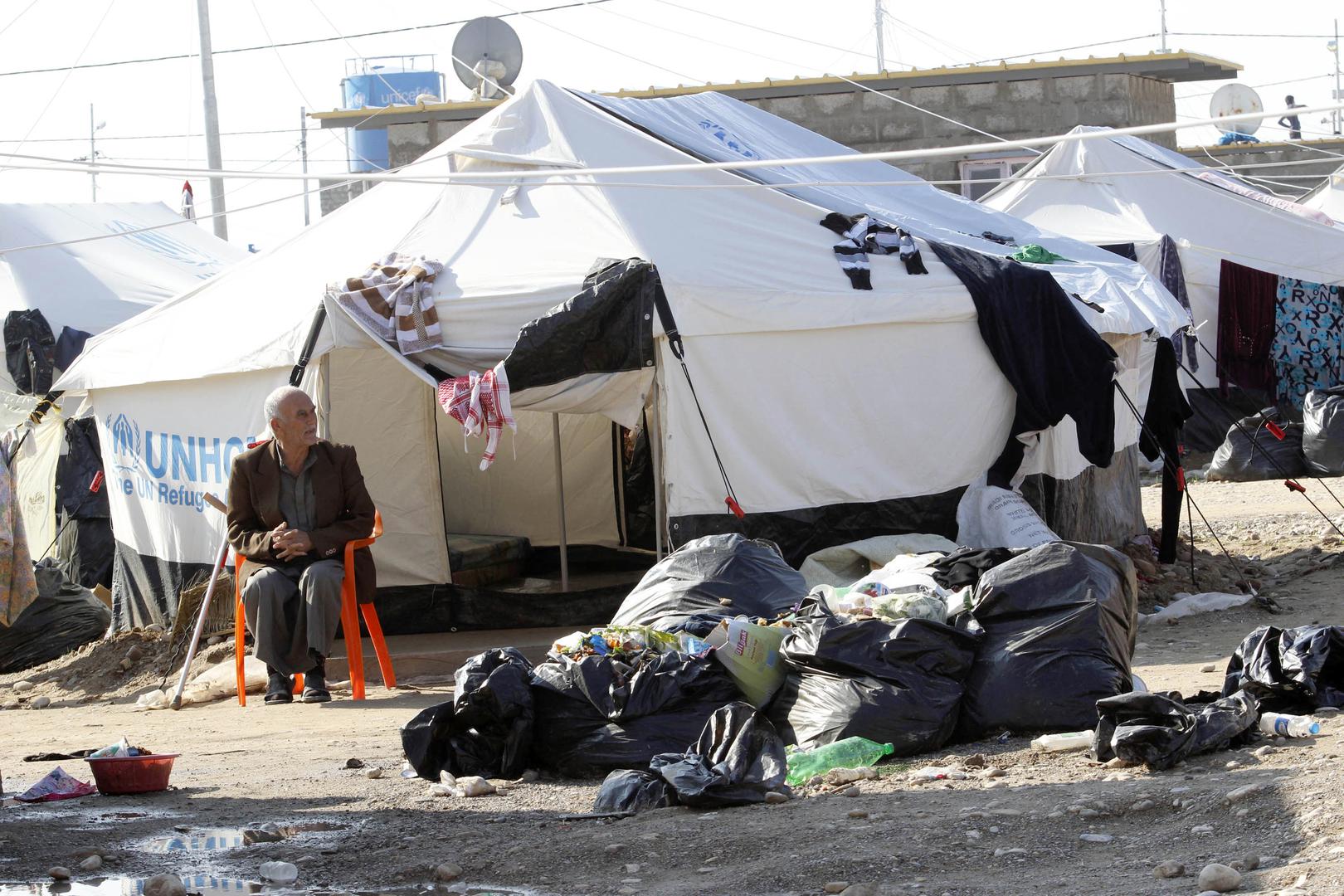 A man sits on a chair at a camp for internally displaced persons on the outskirts of Kirkuk, December 17, 2014. © 2014 Reuters