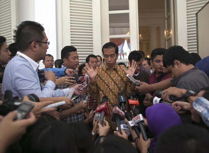 Indonesia's President-elect Joko Widodo (C) speaks with journalists at city hall in Jakarta, August 12, 2014.