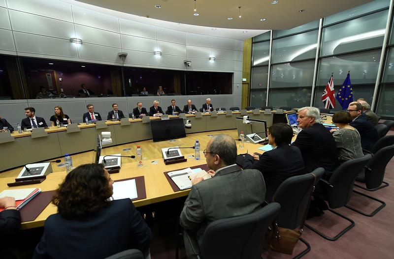 Britain's Secretary of State for Exiting the European Union David Davis and his delegation sit across from European Union's chief Brexit negotiator Michael Barnier and his delegation at the start of their first day of talks at the European Commission in B