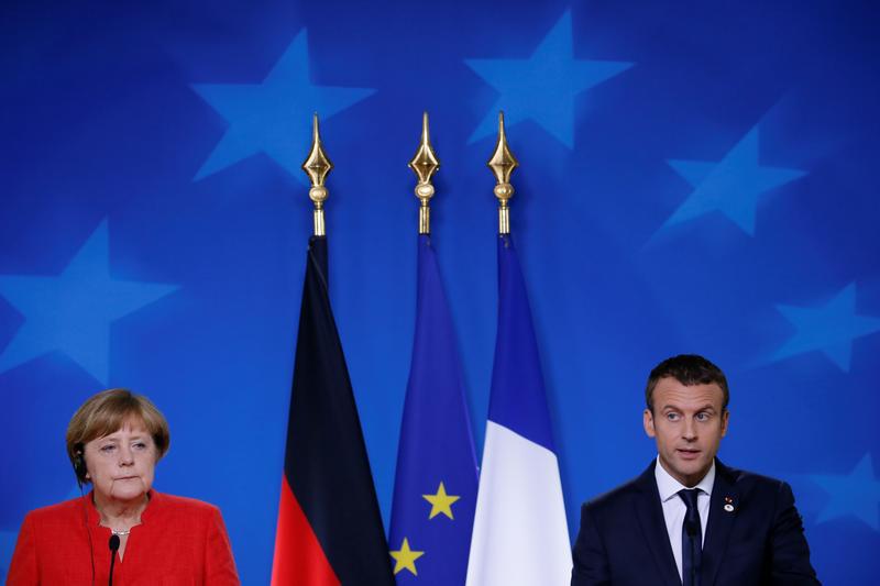 German Chancellor Angela Merkel and French President Emmanuel Macron addresses a joint news conference at the EU summit in Brussels, Belgium, June 23, 2017.