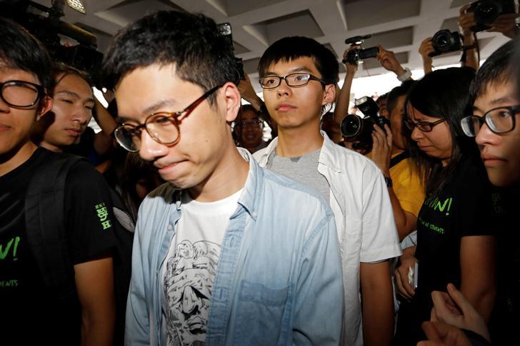 Student leaders Nathan Law and Joshua Wong walk into the high court in Hong Kong, August 17, 2017. 