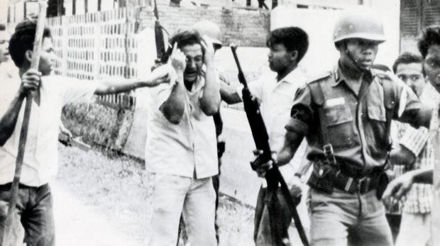 A student is led away after a raid on a university in Jakarta, Indonesia in 1965.