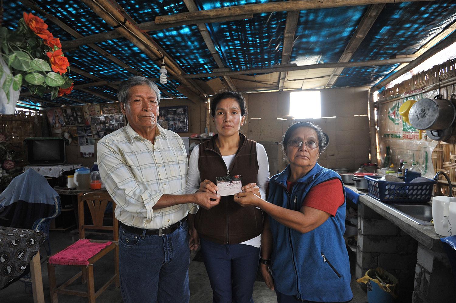 Antenor Hoyos Cubas and María Concepción Sagastegui Tapia, with their daughter, at their home in the outskirts of Lima, Peru, May 2017. Soldiers forcibly disappeared the couple’s son Nelson in June 1992.