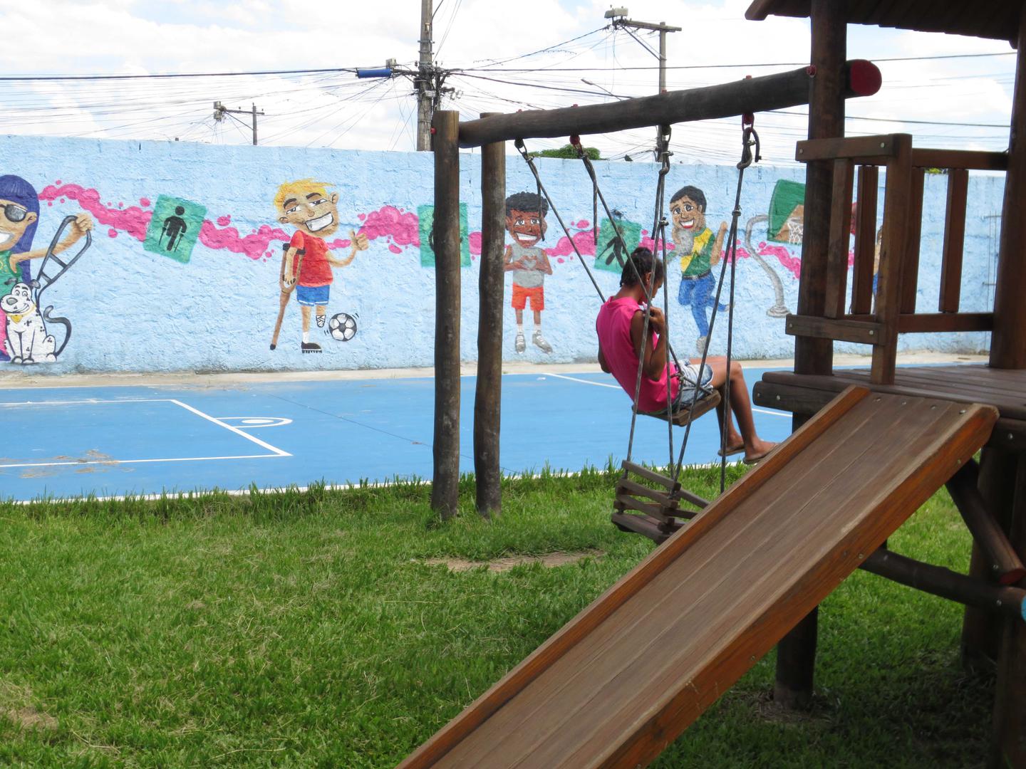 A girl with a disability in the walled yard of an institution for people with disabilities in Rio de Janeiro.