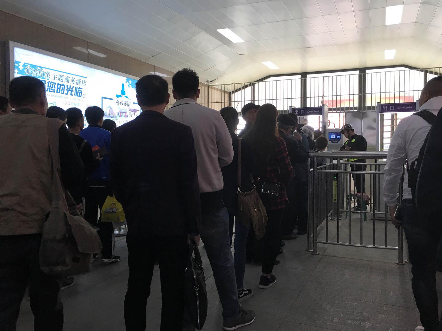A checkpoint equipped with facial recognition in Turpan, Xinjiang. The photographer noted that police let Han through a fast lane without checking them while Turkic Muslims were in long lines waiting for a thorough security check. 