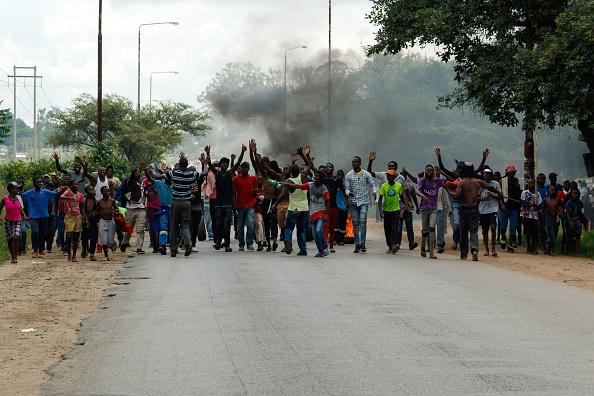 Protesters block the main route to Zimbabwe's capital, Harare, from Epworth township on January 14 2019 after a hike in fuel prices was announced. © 2019 JEKESAI NJIKIZANA/AFP/Getty Images