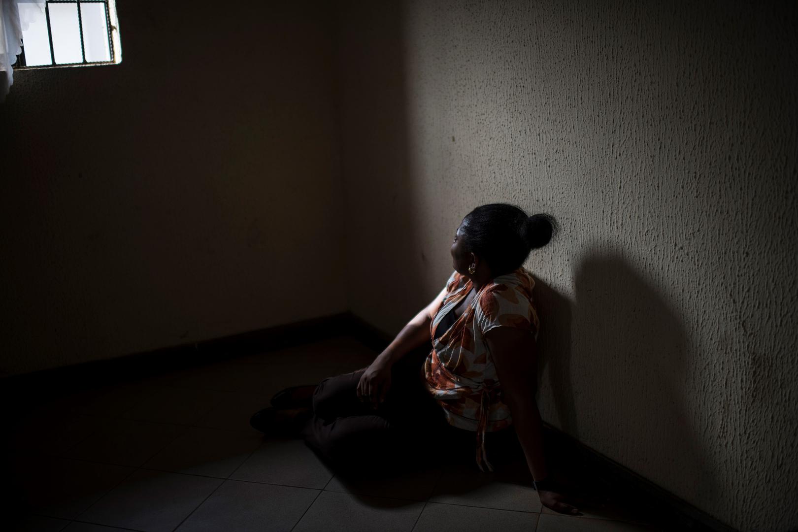 A Nigerian woman sits in a center in Benin City. 