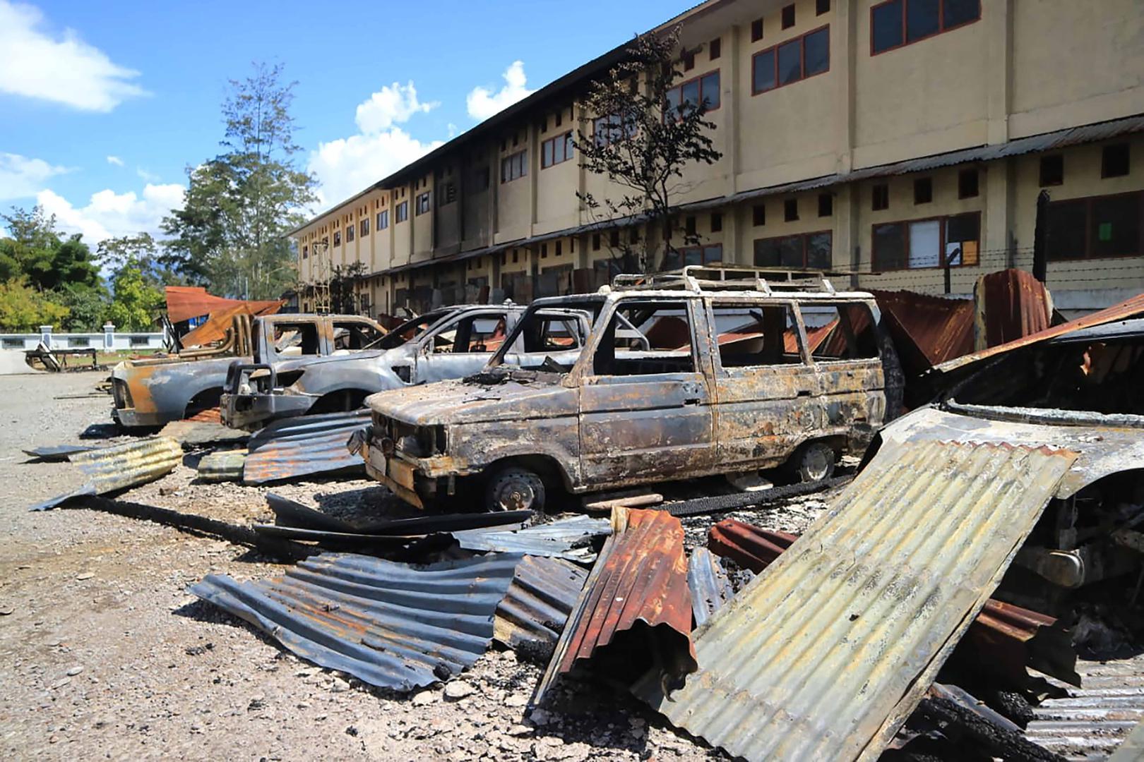 Burnt out vehicles stretch across a parking lot from Monday's violent protest in Wamena, Papua province, Indonesia, Tuesday, Sept. 24, 2019. 