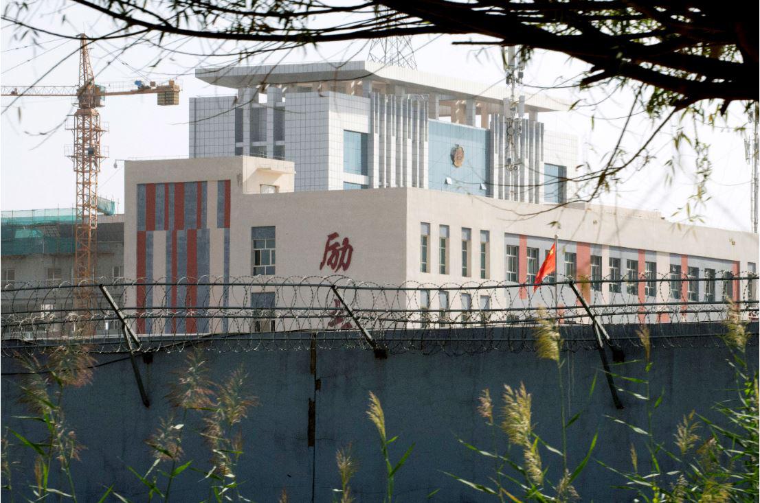 Barbed wire surrounds the walls around a cluster of schools on the outskirts of Kashgar, in western China's Xinjiang region, August 31, 2018. 