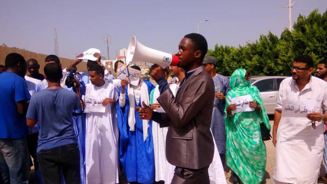 Students protesting against a discriminatory government decision limiting enrollment in public university to 24 years, hold up signs that say “education is a right for all.”