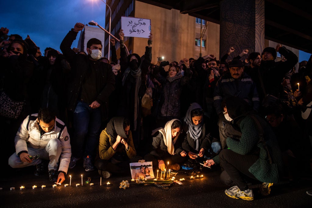 Mourners light candles while gathering during a vigil for the victims of the Ukraine International Airlines flight that was unintentionally shot down by Iran, in Tehran, Iran, on Saturday, Jan. 11, 2020. 