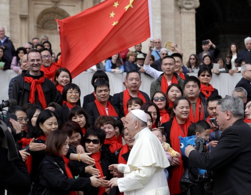 Pope Francis meets a group of faithful from China at the end of his weekly general audience in St. Peter's Square, at the Vatican, April 18, 2018.