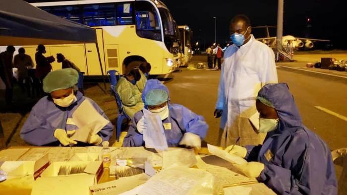 CDC Cameroon Associate Director for Program and Science, Dr. Clement Ndongmo, observes Covid-19 testing procedures for passengers arriving at Nsimalen International Airport in Yaoundé. 