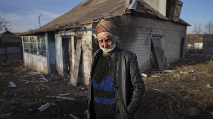 Tetyana Tomenko in front of her house, which was damaged during shelling in Novognativka, eastern Ukraine, February 20, 2022.