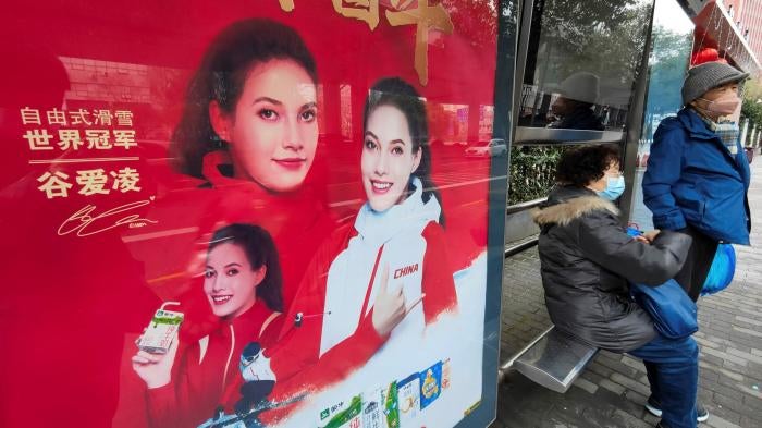An advertisement featuring Eileen Gu, also known by her Chinese name Gu Ailing, at a bus stop in Shanghai, China, Wednesday, February 9, 2022.