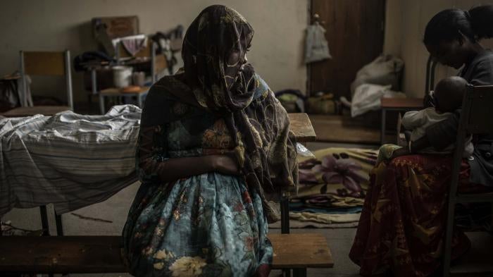 A woman sits at a school being used to house people displaced by fighting, in the city of Mekelle in Ethiopia's northern Tigray region.