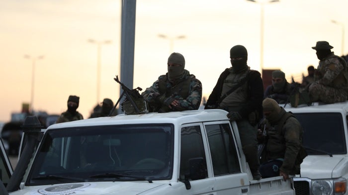 Fighters with the new Syrian government ride in trucks in Tartus, Syria, March 7, 2025, 