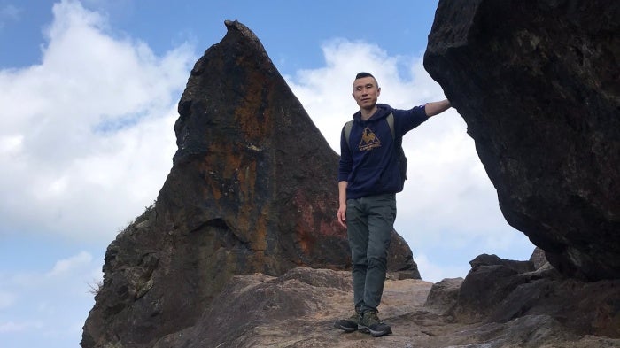 Fu Cha stands on the mountainside