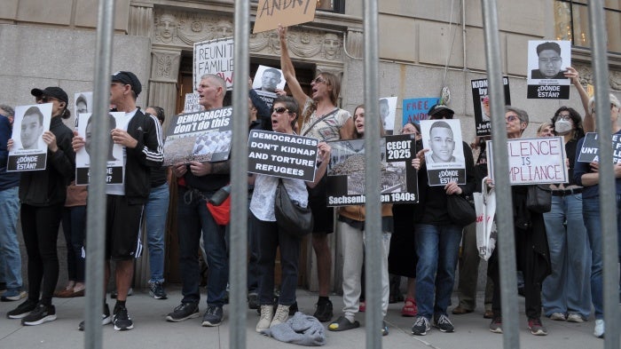 Demonstrators holding up placards
