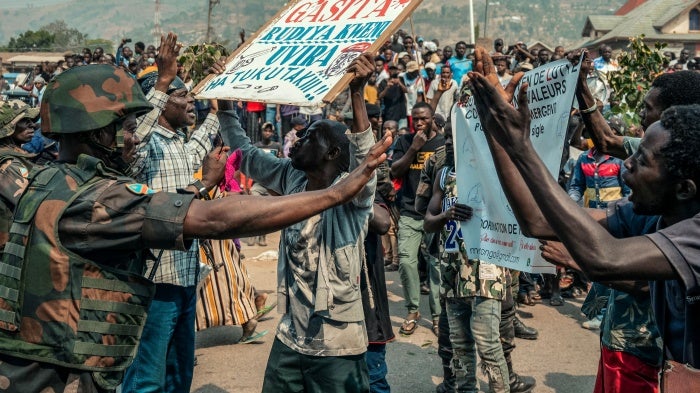 A protestor holds a placard in Uvira, DRC.