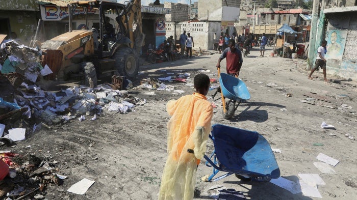 Haiti young people carrying debris