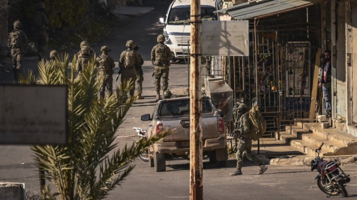  Israeli soldiers patrol in the Syrian village of Jubata al-Khashab, December 20, 2024.