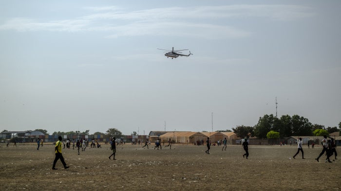 A UN helicopter performs a routine patrol over the Bentiu internally displaced persons camp in Unity State, South Sudan, on November 4, 2025.