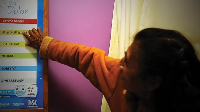 Doña Remedios Ramírez Facio, 73, who has pancreatic cancer, shows a doctor at the palliative care unit of the National Cancer Institute in Mexico how severe her pain was before she was started on morphine.