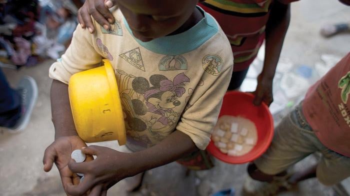 A boy counts his earnings to make sure he has reached the daily begging quota set by his Quranic teacher, in the Medina Gounass suburb of Dakar, Senegal.