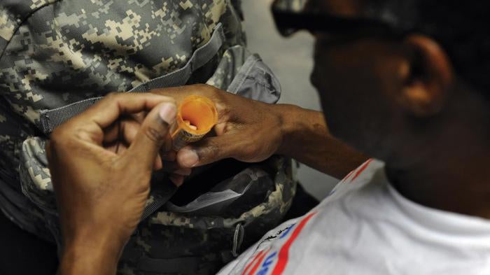 A US military veteran prepares to take his medication at Central Union Mission, in Washington, DC, which provides shelter for homeless men, on November 28, 2011.