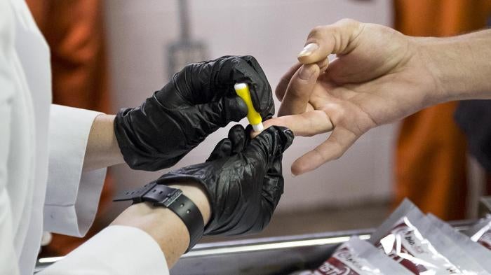 “An inmate receiving a voluntary HIV test at Lafayette Parish Correctional Center, Lafayette, Louisiana.” © 2016 Bryan Tarnowski/Human Rights Watch
