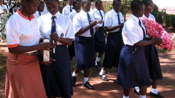 Former abducted Ugandan girls from St. Mary's College in Aboke who returned from captivity by Lord's Resistance Army (LRA) rebels walk with lit candles during a ceremony October 10, 2005 to commemorate the abduction day.