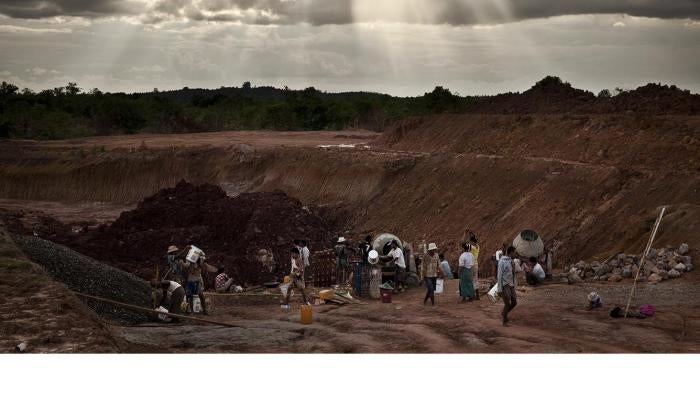 Workers building a water catchment area behind a government-constructed irrigation dam that flooded land belonging to Aung Thay and other villagers from Karen State. 