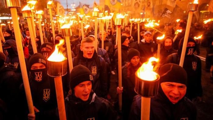 Activists and supporters of the Azov civil corp, Svoboda (Freedom), Ukrainian nationalist parties and the far-right radical group Right Sector take part in a rally to mark Defender of Ukraine Day