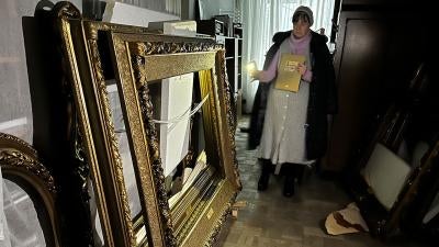 Woman looks at empty art frames
