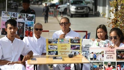 Five Cambodian activists record a podcast.