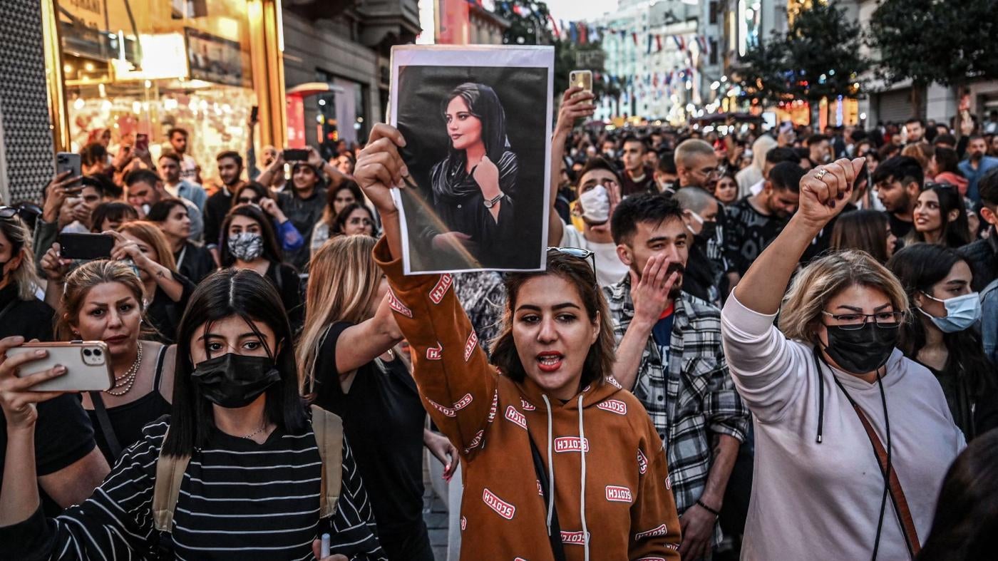 A protester in Istanbul, Turkey, holds a portrait of Mahsa (Jina) Amini during a demonstration on September 20, 2022.