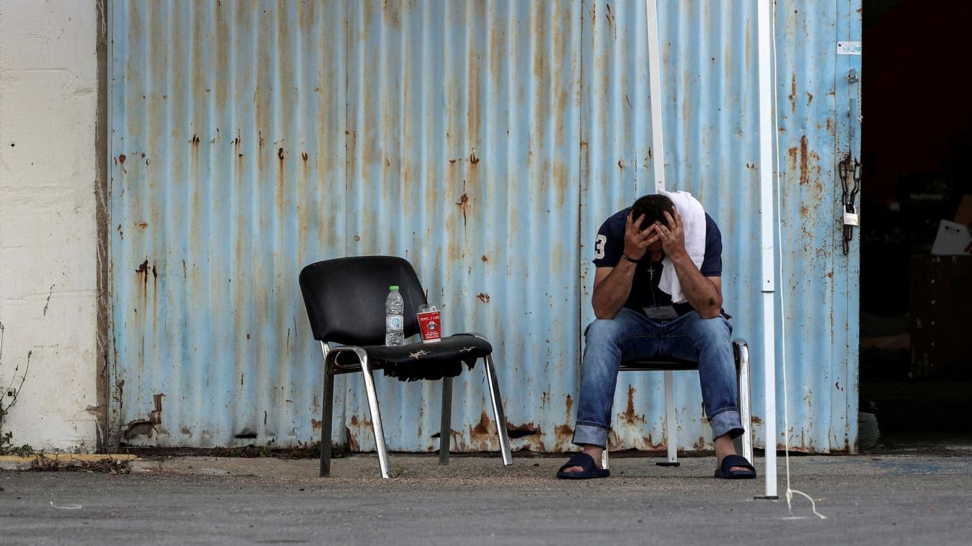 A man who was rescued at sea off the coast of Greece after the boat he and hundreds of other migrants and asylum seekers were on capsized sits at a shelter at the port of Kalamata, Greece, June 15, 2023.