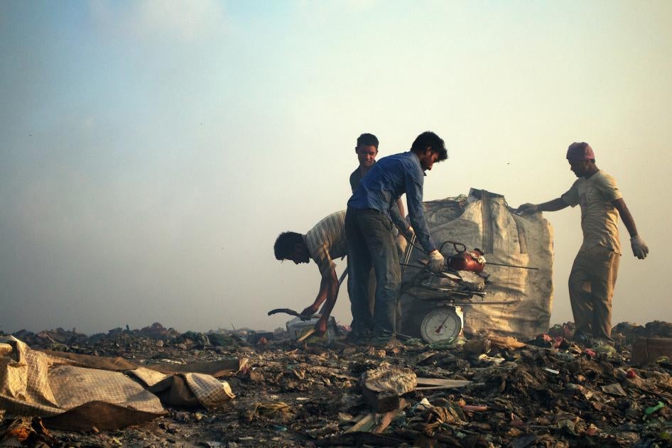 Migrant workers weigh scrap metal, Thilafushi, Maldives.