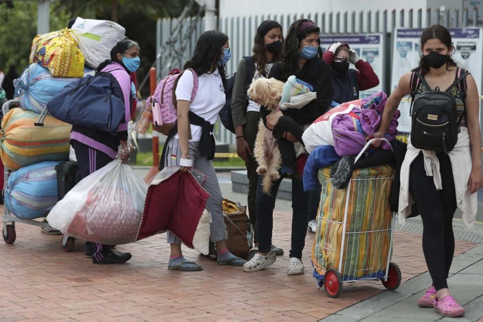 Venezuelan migrants wait for a bus in Bogota, Colombia, to travel to the border with Venezuela during the Covid-19 pandemic, on Thursday, July 2, 2020.