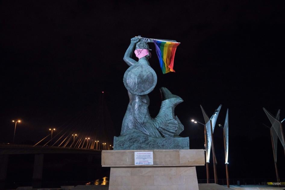The Mermaid of Warsaw statue is seen holding the LGBT rainbow flag and wearing a pink mask with the anarcha-queer symbol in Warsaw, Poland July 29, 2020 in this image taken from social media.