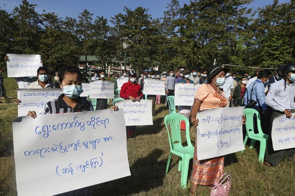 Protesters hold placards that read "Oppose unfair action of election! Investigate voting fraud around the country!" in a rally to condemn the November 8 general election results in Yangon, Myanmar on Friday, November 20, 2020.