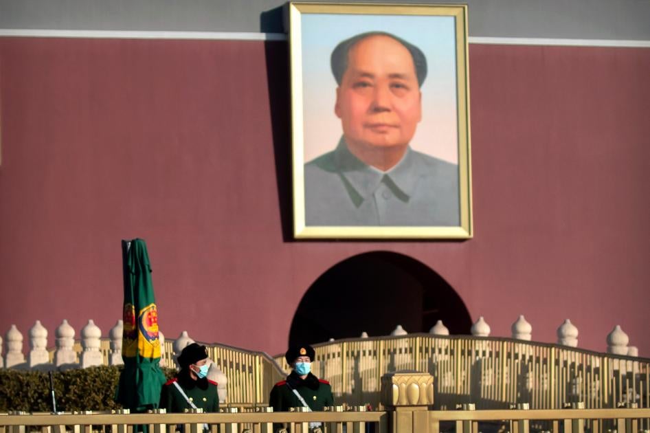 Chinese paramilitary police wearing face masks to protect against the spread of the coronavirus stand guard near the portrait of Chinese leader Mao Zedong on Tiananmen Gate near Tiananmen Square in Beijing on Saturday, January 9, 2021. 