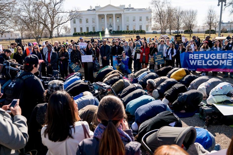 In this file photo, people protest the Trump administration's refugee policies outside the White House in Washington, January 27, 2018. 