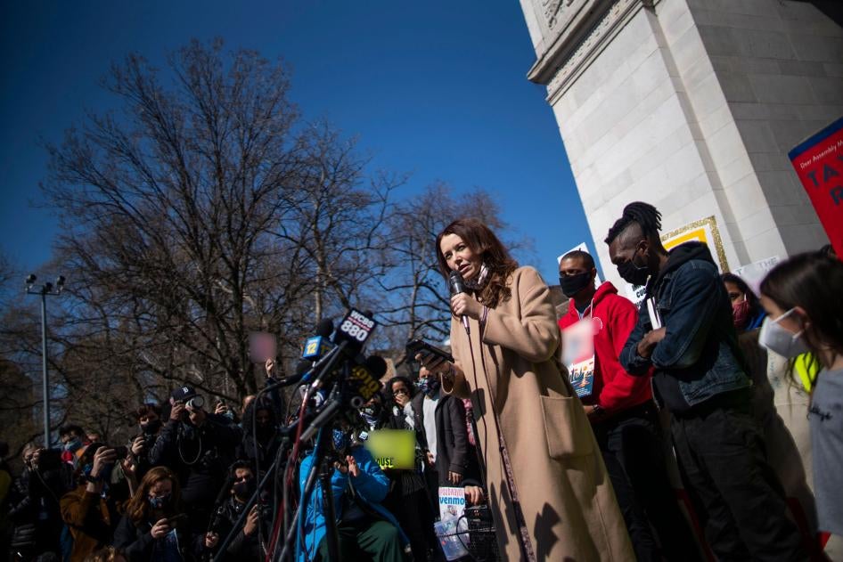 Lindsey Boylan, a former state economic development adviser for New York Governor Andrew Cuomo, speaks in front of microphones and a crowd of people holding signs at a rally in New York City, March 20, 2021. 