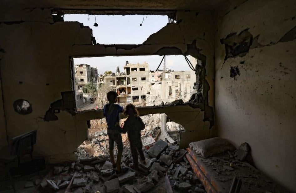 Palestinian children observe the damage from homes Gaza City