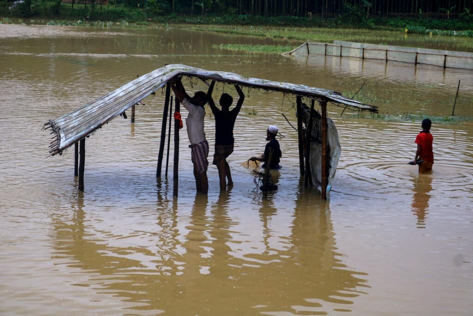 Rohingya refugees repair a shelter damaged following heavy rains at the refugee camp in Kutupalong, Bangladesh on July 28, 2021.