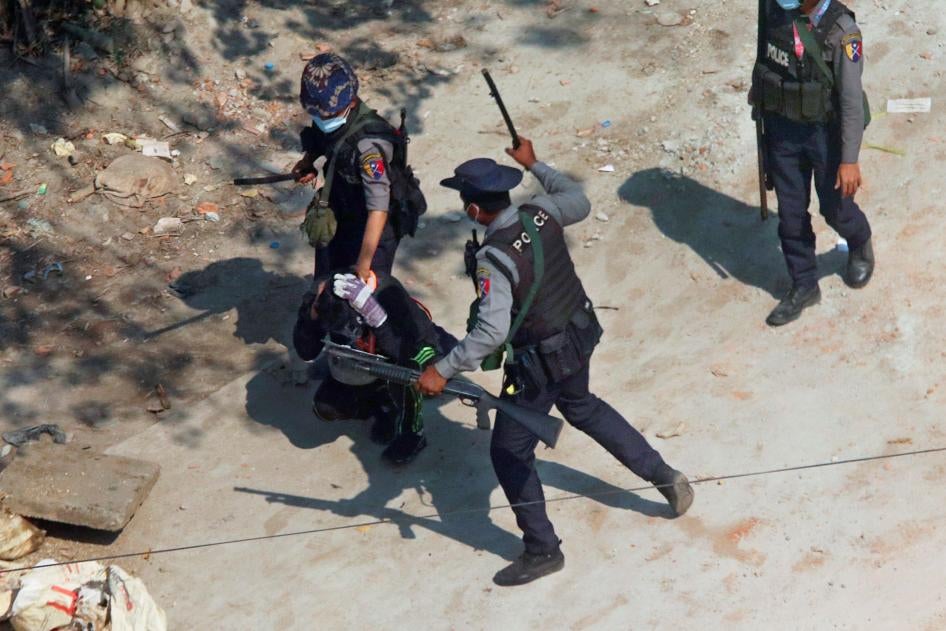 Police officers hold down a protester as they disperse demonstrators in Yangon, March 6, 2021.